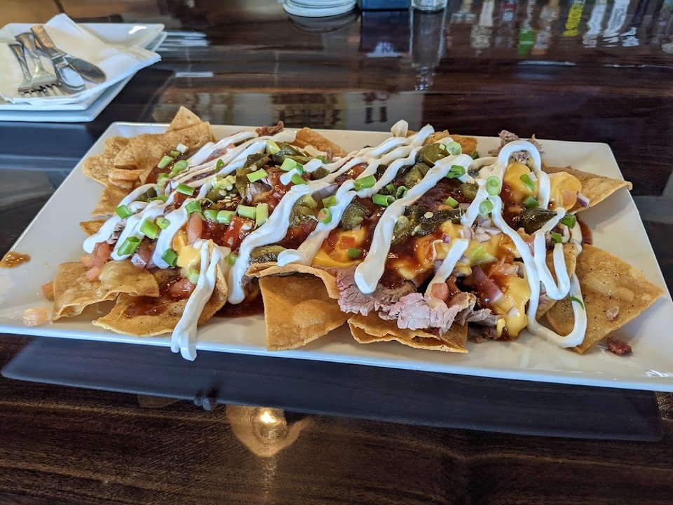 Restaurant menu listing comfort food and small plates.